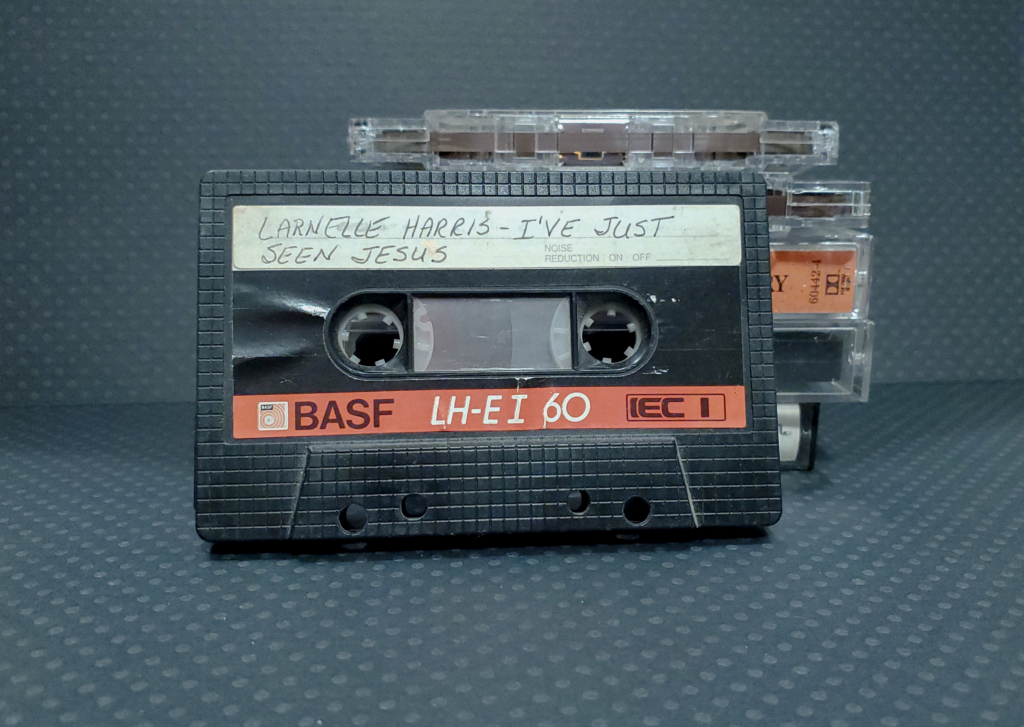 A photograph of audio cassette tapes against a dark gray background
