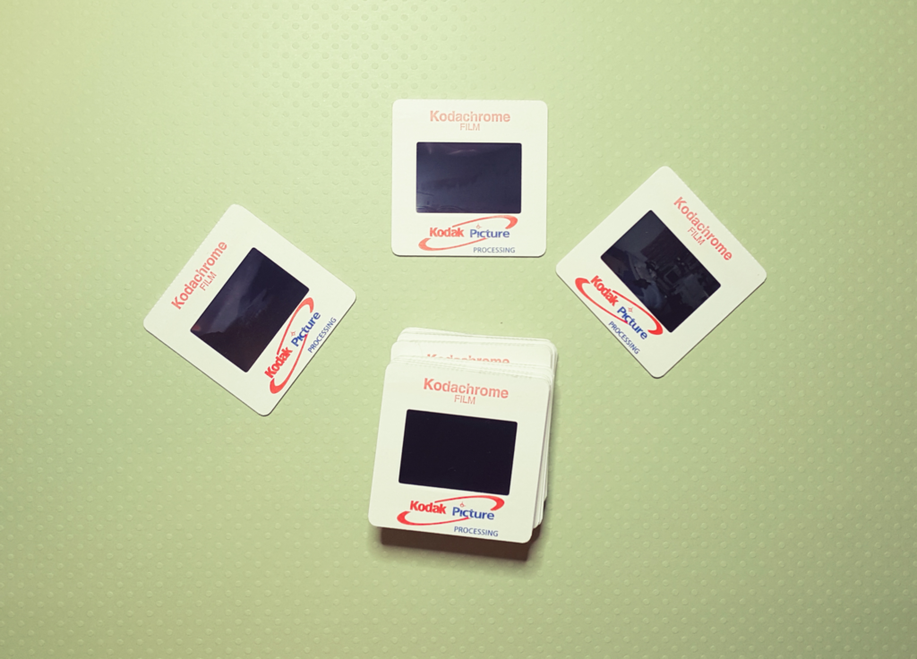 A photograph of slides on a light green background